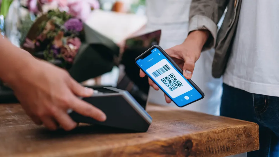 a man is paying with qr code