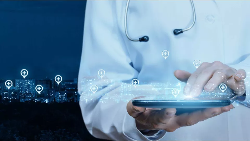 A doctor holding a tablet with digital icons